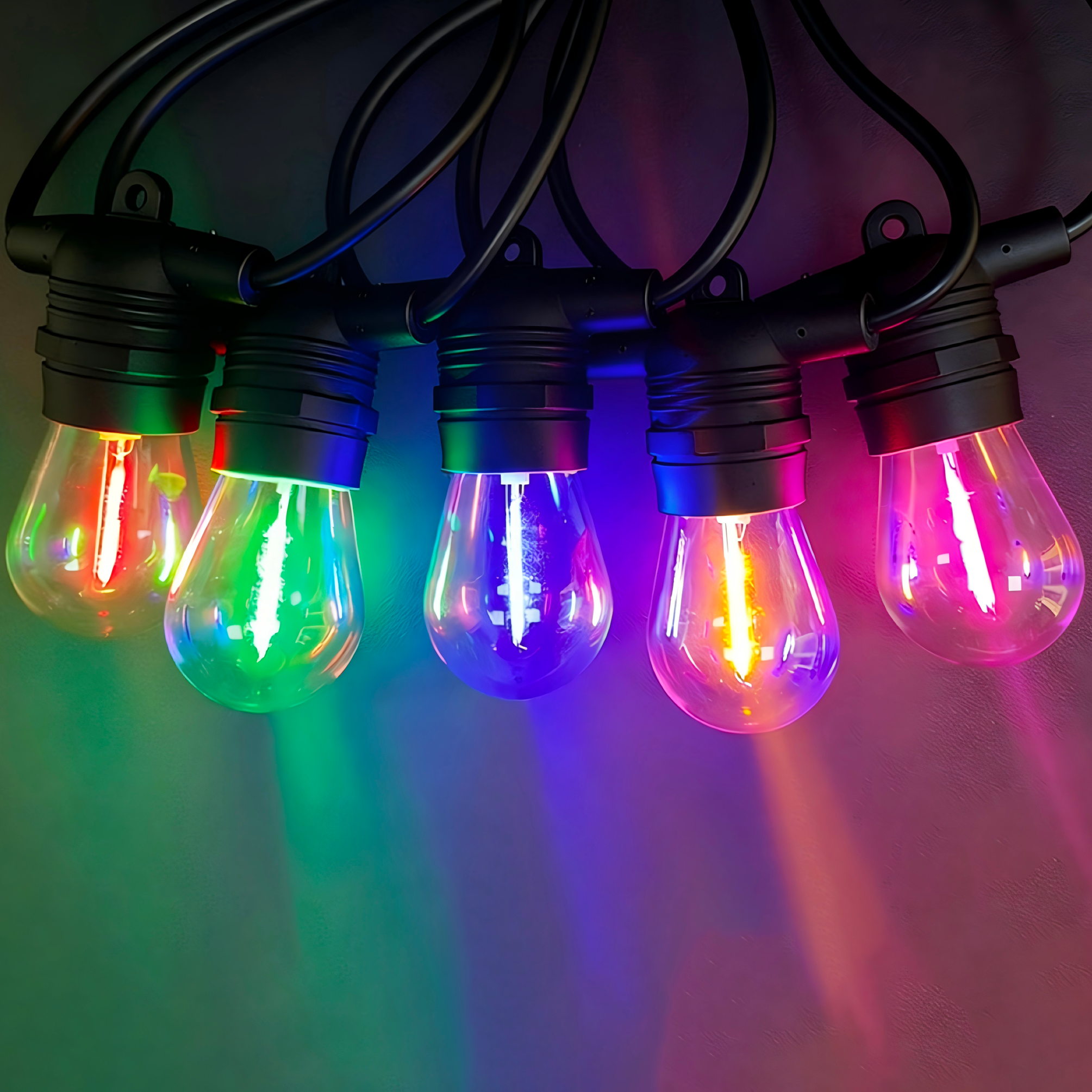 String of colorful light bulbs on a dark background